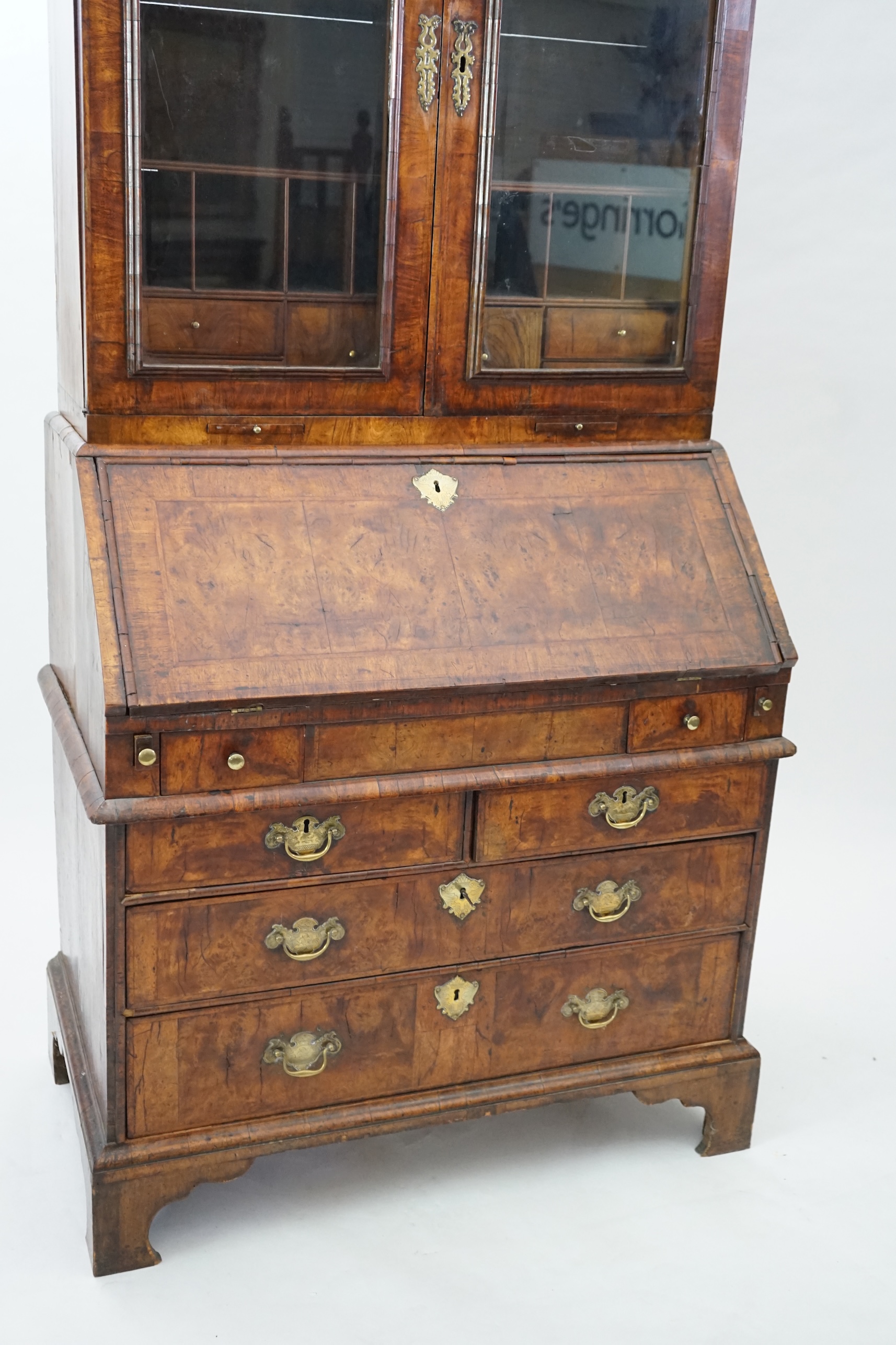 An early 18th century walnut bureau bookcase